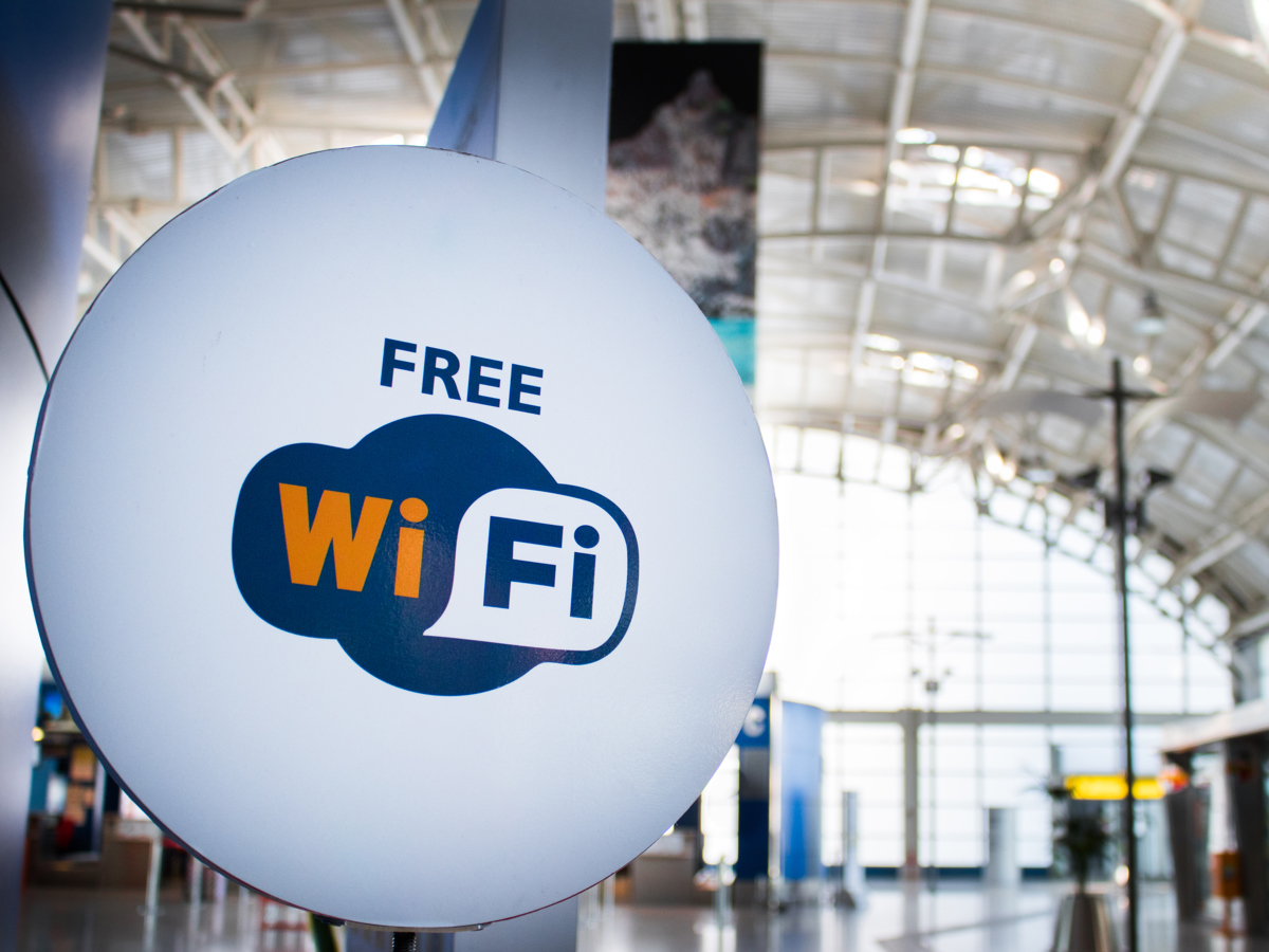A free Wi-Fi sign in an airport illustrates a use case for MBSI WAV’s Wi-Fi solutions for public spaces.
